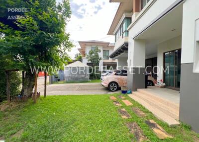 Front view of a modern house with driveway and garden