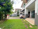 Front view of a modern house with driveway and garden