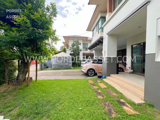 Front view of a modern house with driveway and garden