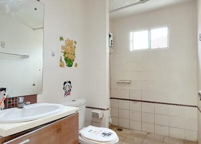 Well-lit bathroom with shower and modern fixtures