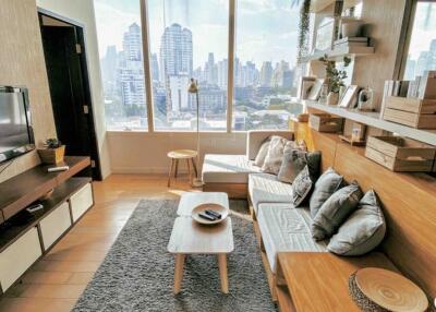 Bright living room with large windows and modern furniture