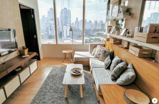 Bright living room with large windows and modern furniture