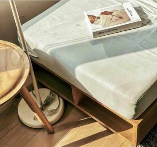 Sunny bedroom corner with bed and book