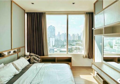 Modern bedroom with large window and city view