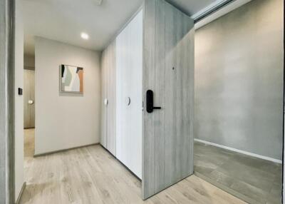 Modern hallway with light wood flooring and artwork