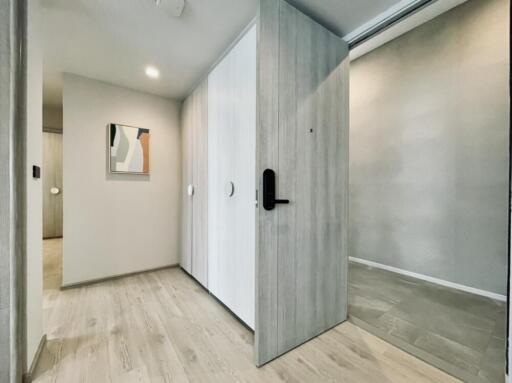 Modern hallway with light wood flooring and artwork