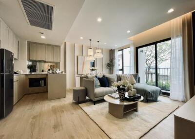 Modern open-concept living area with kitchen, living room, and dining space