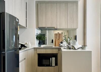 Modern kitchen with wooden cabinets and black appliances