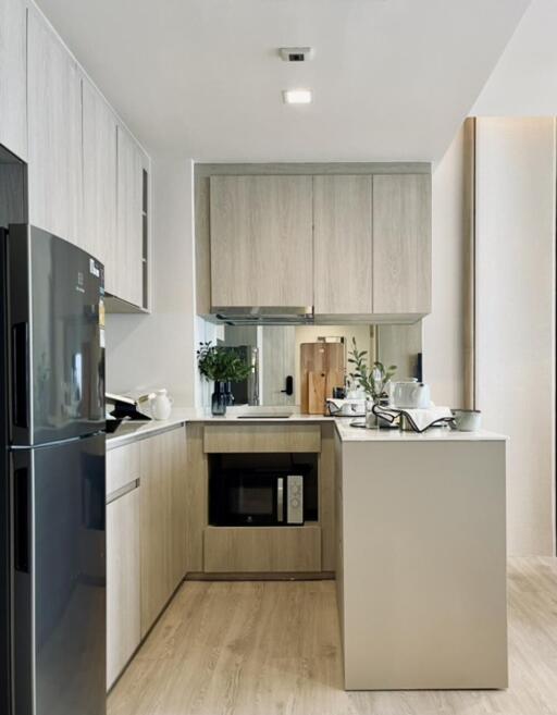 Modern kitchen with wooden cabinets and black appliances