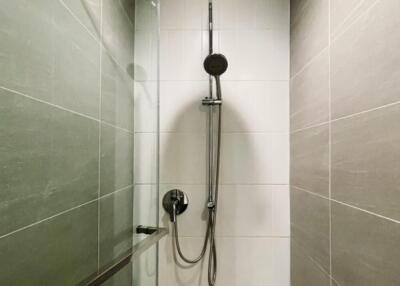 Modern shower area with overhead and handheld showerheads