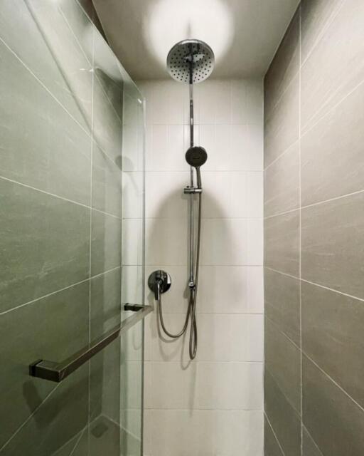 Modern shower area with overhead and handheld showerheads