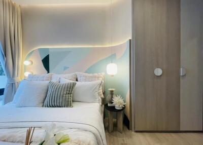 Modern bedroom with bed, closet, and decorative lighting