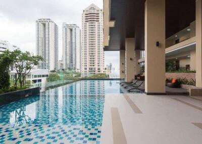 Modern outdoor swimming pool area with city view