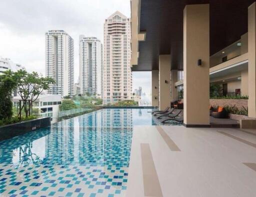 Modern outdoor swimming pool area with city view