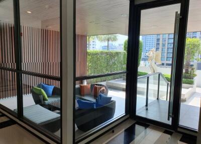 Modern patio with glass walls and seating area