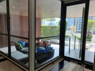 Modern patio with glass walls and seating area