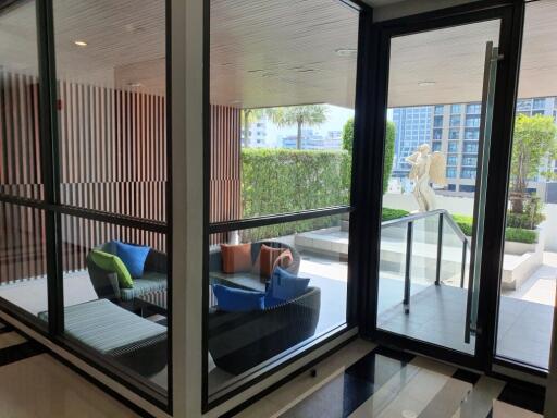 Modern patio with glass walls and seating area