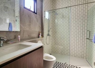 Modern bathroom with glass shower and patterned floor tiles