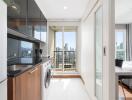 Modern kitchen with appliances and view of bedroom and balcony