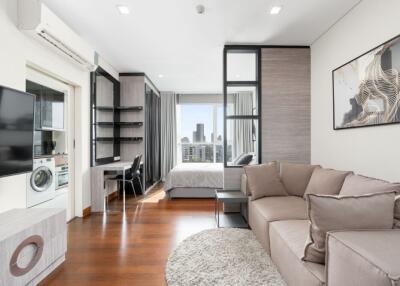 Modern living room with an open view into a bedroom