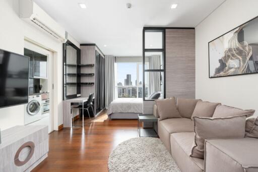 Modern living room with an open view into a bedroom