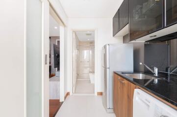 Modern kitchen with appliances and view of bathroom