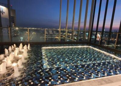 Rooftop pool night view with cityscape