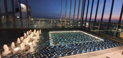 Rooftop pool night view with cityscape