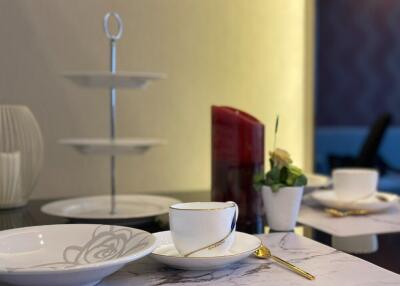 Dining table with cups, plates, and a candle