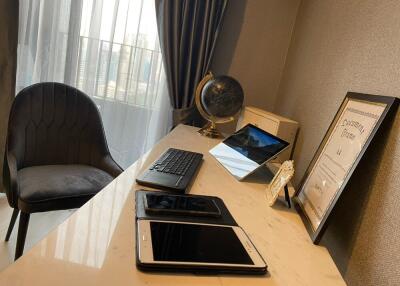 A neatly organized home office with a desk, chair, and various electronic devices