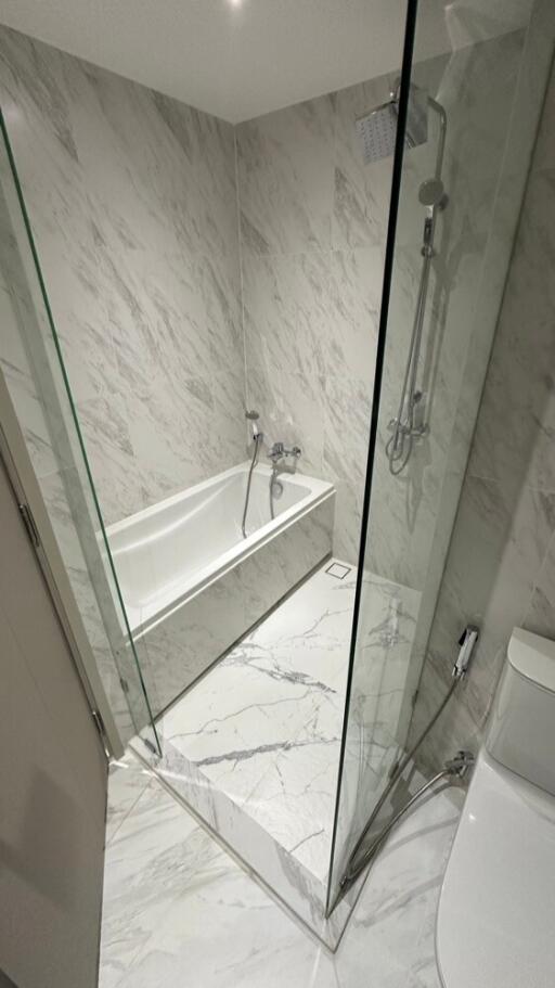 Modern white marble bathroom with bathtub and shower