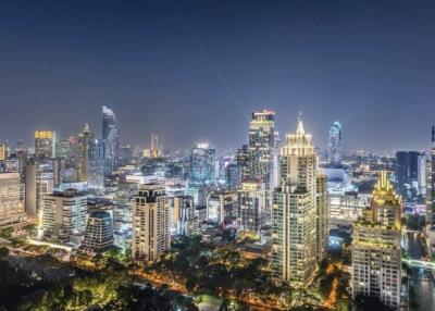 Night view of a modern city skyline with illuminated skyscrapers