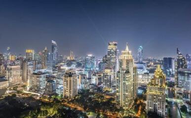 Night view of a modern city skyline with illuminated skyscrapers