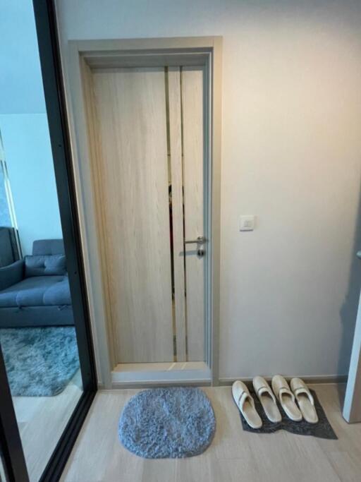 Modern entryway with door and slippers