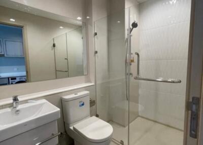 Modern bathroom with a shower area, toilet, and sink