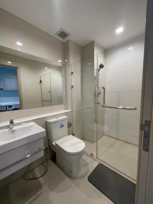 Modern bathroom with a shower area, toilet, and sink