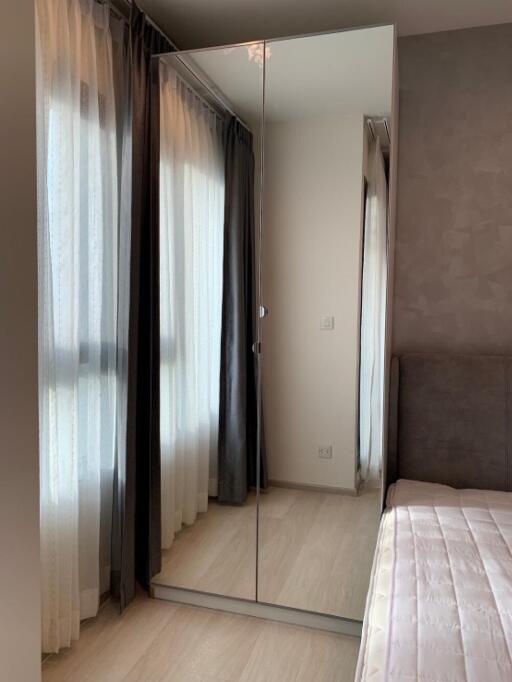 Bedroom with mirrored wardrobe and large windows