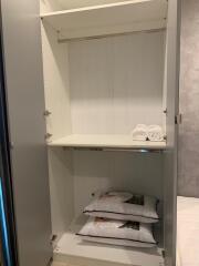 Empty closet with shelves and folded towels