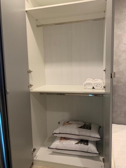 Empty closet with shelves and folded towels