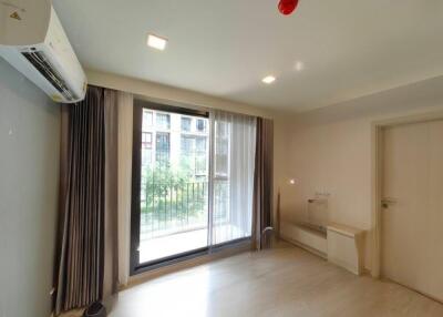 Bright living room with large windows and balcony access