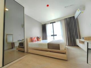 Bright modern bedroom with large bed, mirror wardrobe, and study desk