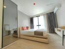 Bright modern bedroom with large bed, mirror wardrobe, and study desk