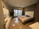 Spacious modern bedroom with large bed and floor-to-ceiling window