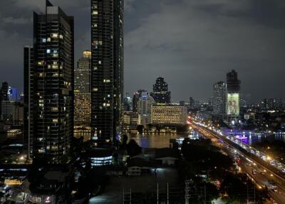 Cityscape view of high-rise buildings and illuminated streets at night