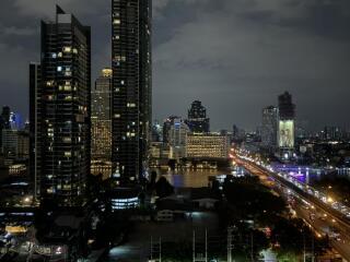 Cityscape view of high-rise buildings and illuminated streets at night