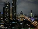 Cityscape view of high-rise buildings and illuminated streets at night