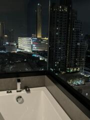 View from the bathroom over a cityscape at night