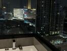 View from the bathroom over a cityscape at night