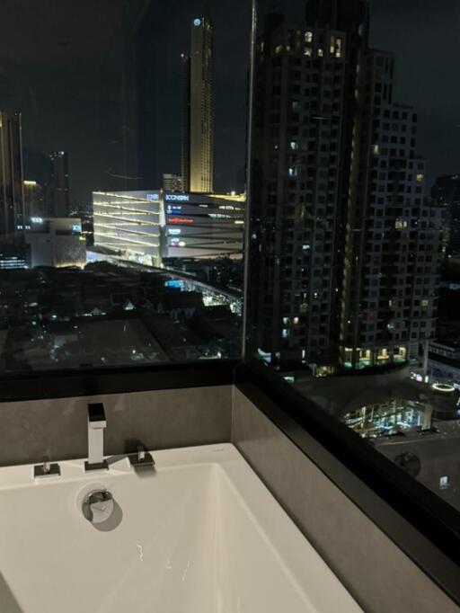 View from the bathroom over a cityscape at night