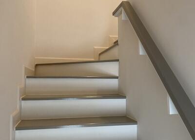 Staircase with gray steps and white walls